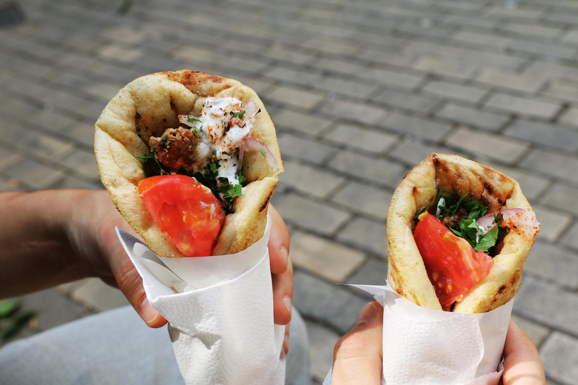 Vegan souvlaki wrap with fresh vegetables and pita at an Athens street food counter
