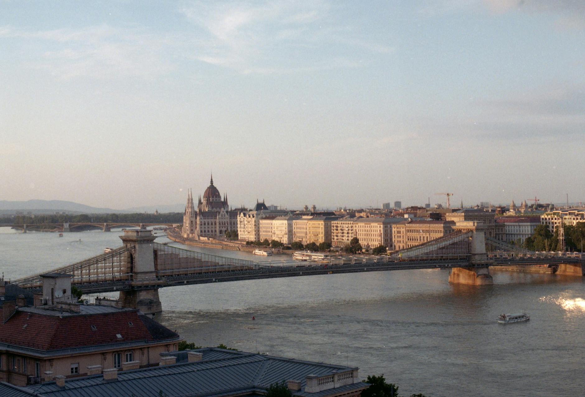 Budapest Parliament at dusk along the Danube with cruise ships moored at the bank