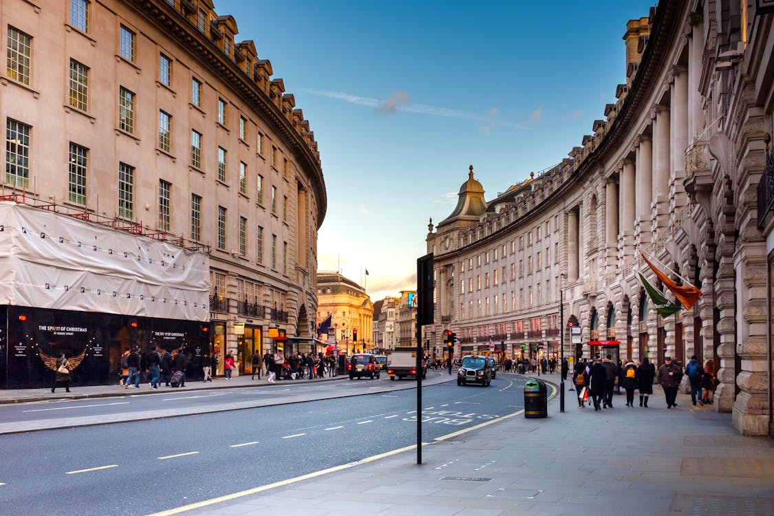 City street scene with buildings and pedestrians on a hybrid tour combining vehicle transfers and walking
