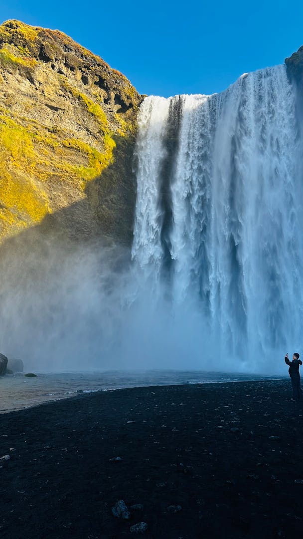 Skogafoss waterfall roaring through Iceland's south coast landscape