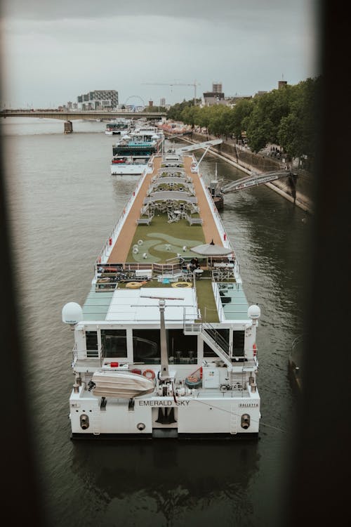 High-angle view of a cruise ship sailing on a European river, showing the smaller scale of river vessels