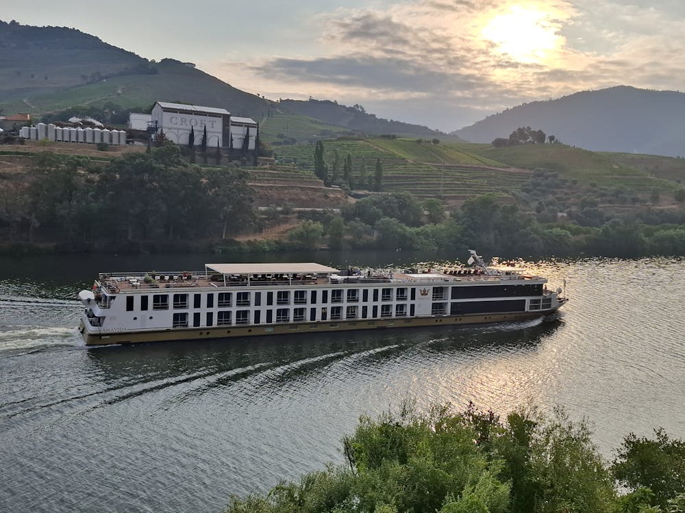 River cruise boat at sunset on a scenic waterway