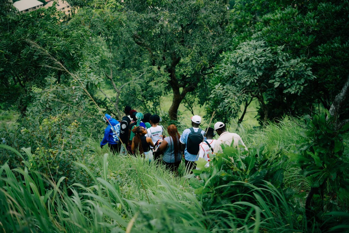 A small group of hikers with backpacks on a mountain trail, intimate enough for conversation, social enough for connection