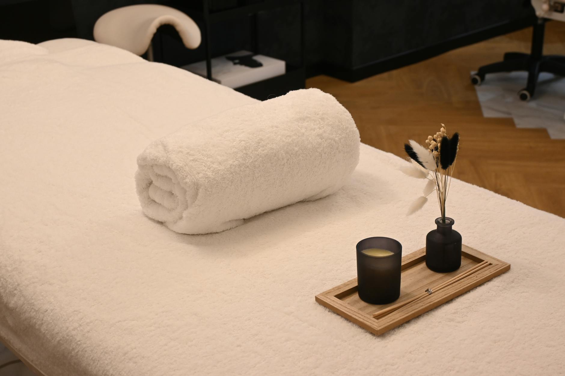 Massage treatment room with candles, towels, and warm lighting at a Paris luxury hotel spa