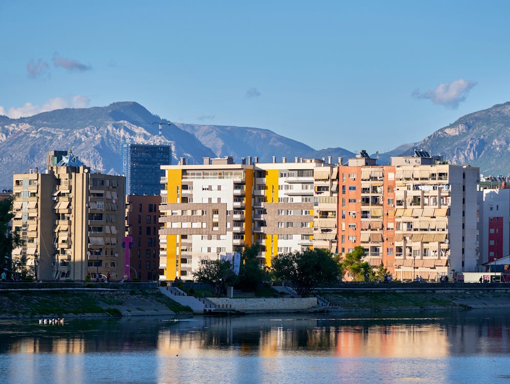 Colorful apartment buildings and cityscape of Tirana, Albania's capital, with mountain backdrop