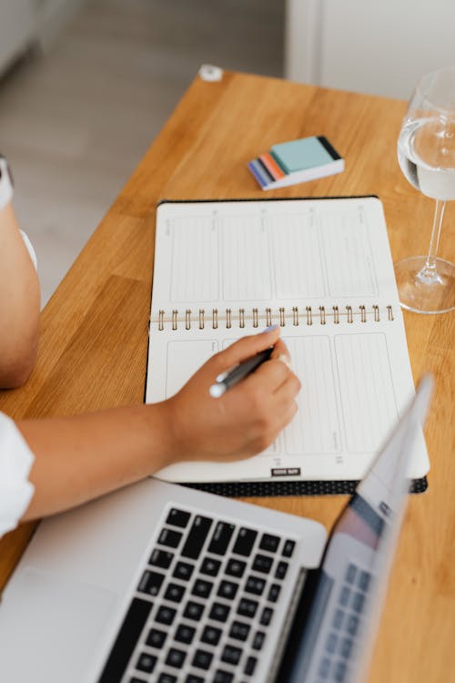 Travel planning calendar with notes and a pen, timing a tour booking correctly