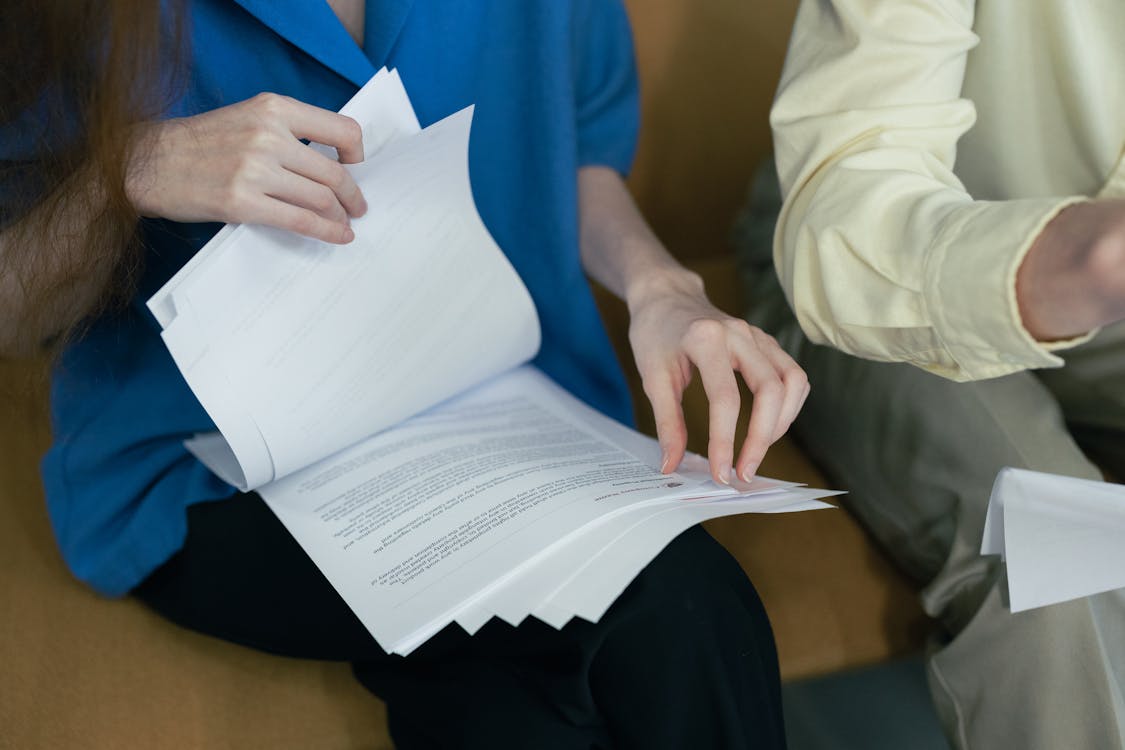 People in professional attire reviewing important documents, the kind of due diligence that protects travelers before booking