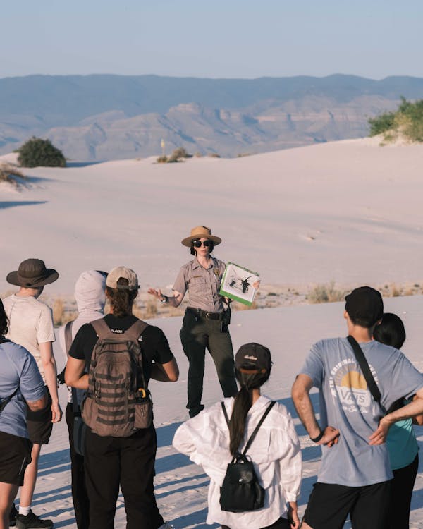 Group of tourists exploring a national park with a qualified, knowledgeable guide leading the way