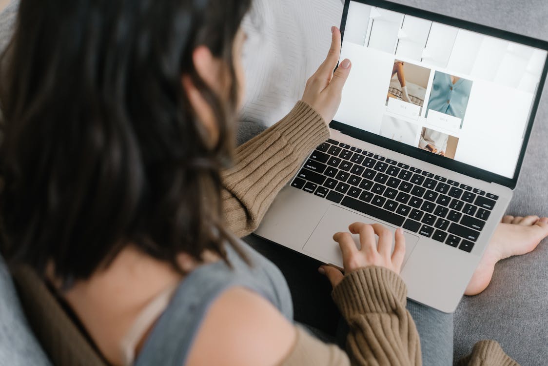 A woman browsing tour options on a laptop at home, taking time to compare before booking