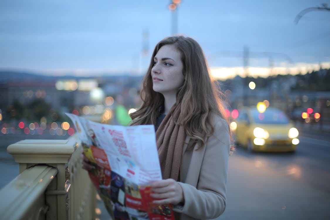 Traveler consulting a map on a city street before deciding which tour format to book