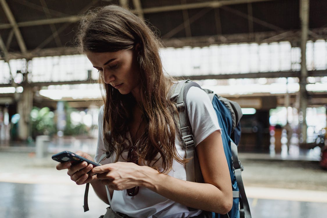 A traveler reading reviews and research on a phone before committing to a tour booking