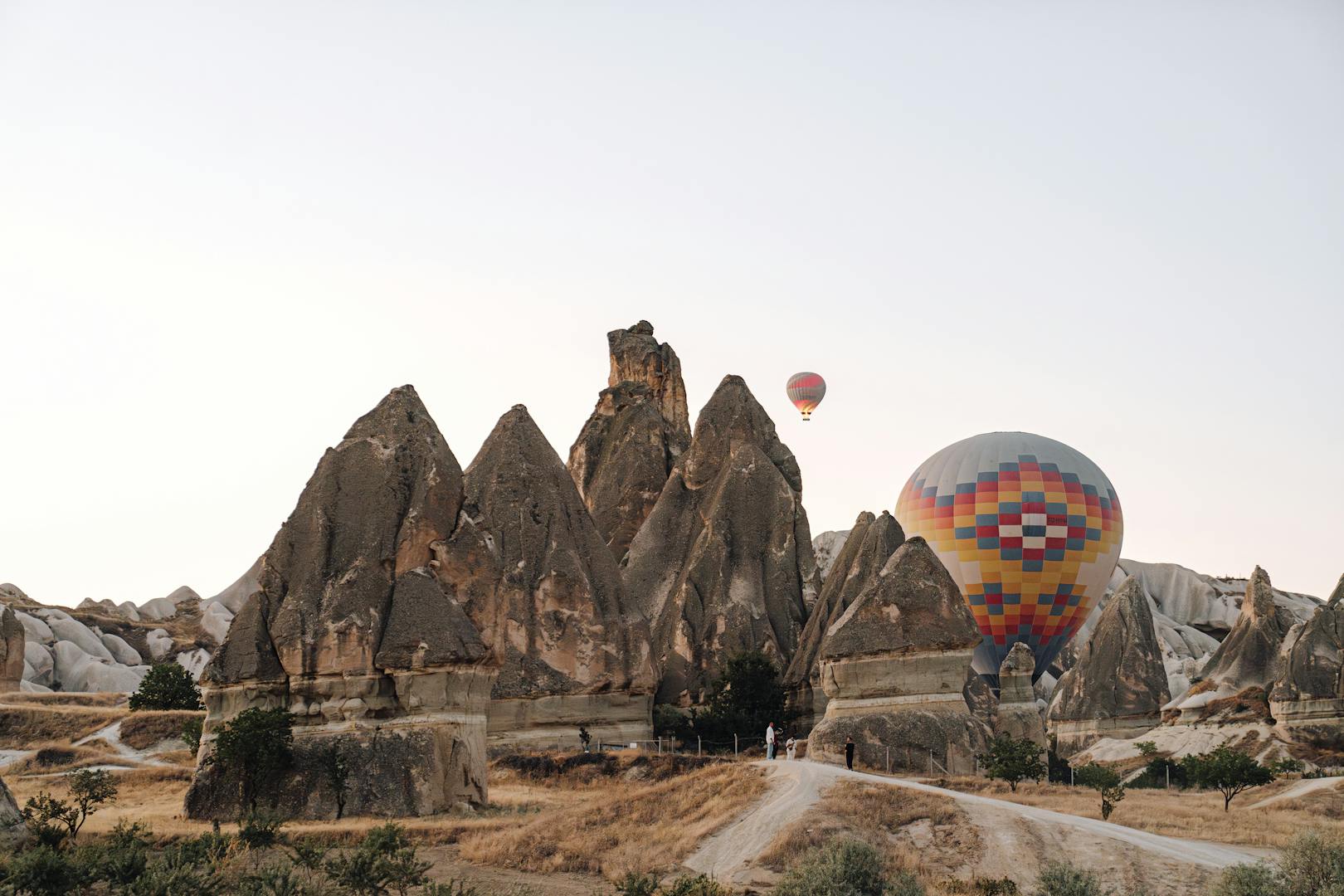Hot air balloons over the fairy chimneys of Cappadocia at sunrise