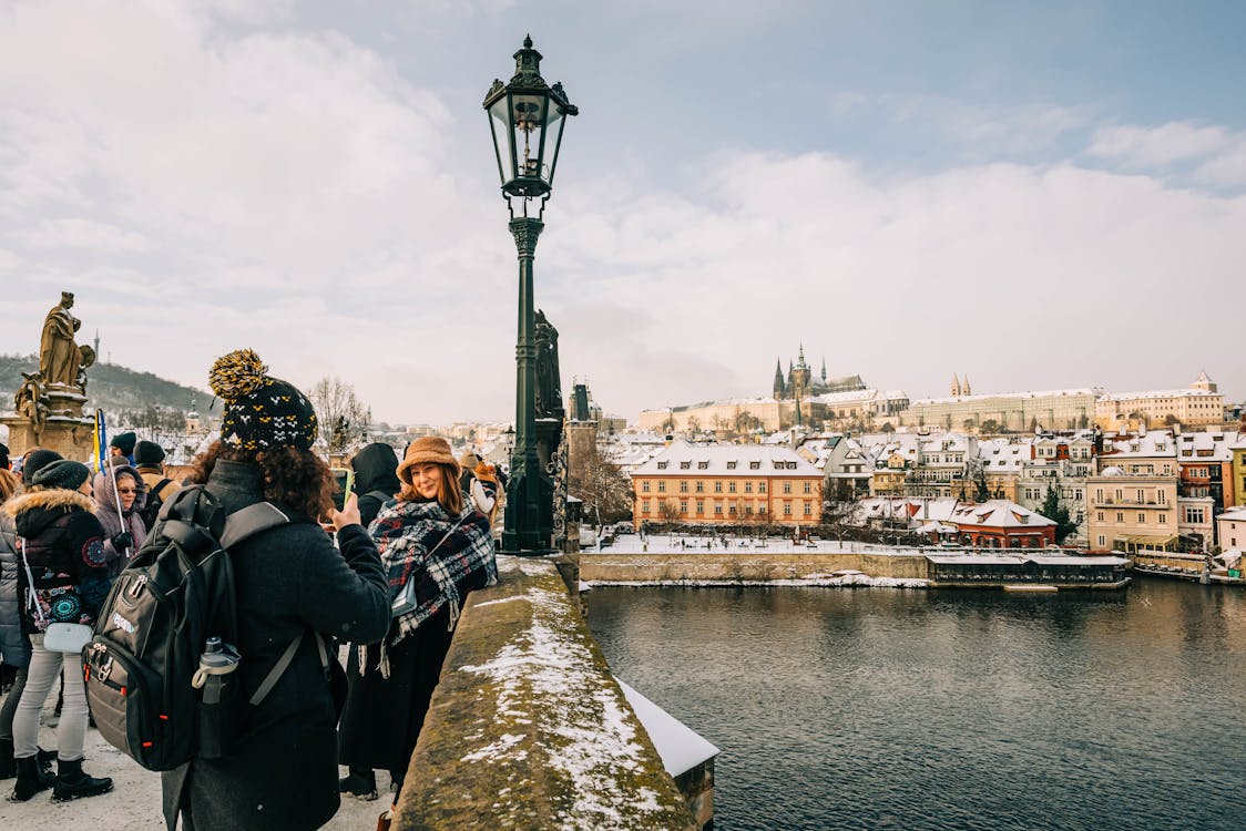 Tourists crossing a historic bridge on a walking city tour