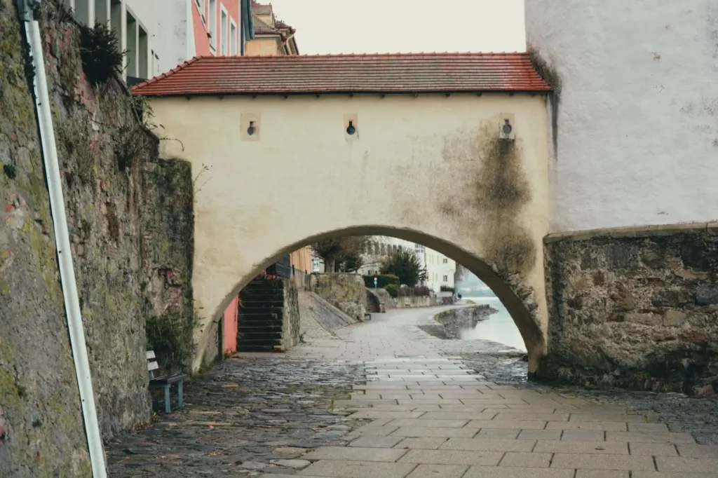 Best Danube River Cruises for First-Timers: What to Book and Why ToursZoom Sunlight illuminating the historic cobblestone streets of Passau, Germany