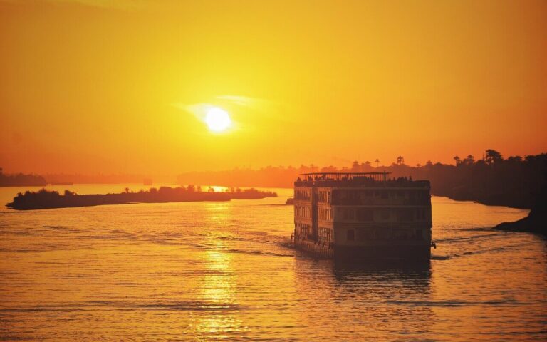 A luxurious Nile river cruise ship sailing on the Nile at sunset