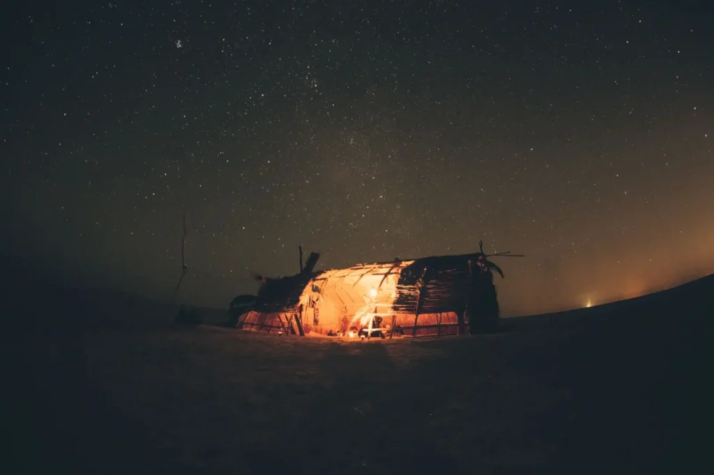 Traditional Bedouin camp fire glowing under starlight in Dubai's desert