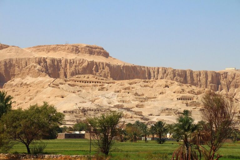 Sunrise over the Nile with the Valley of the Kings appearing from sand-colored cliffs