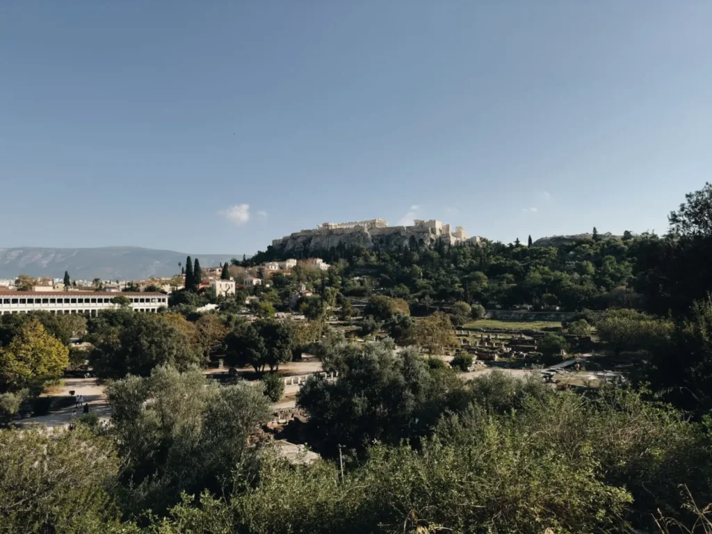 Greece tours in June: Early summer island hopping and cultural routes ToursZoom The Acropolis in Athens under the midday sun, highlighting its historical significance amidst the heat of June