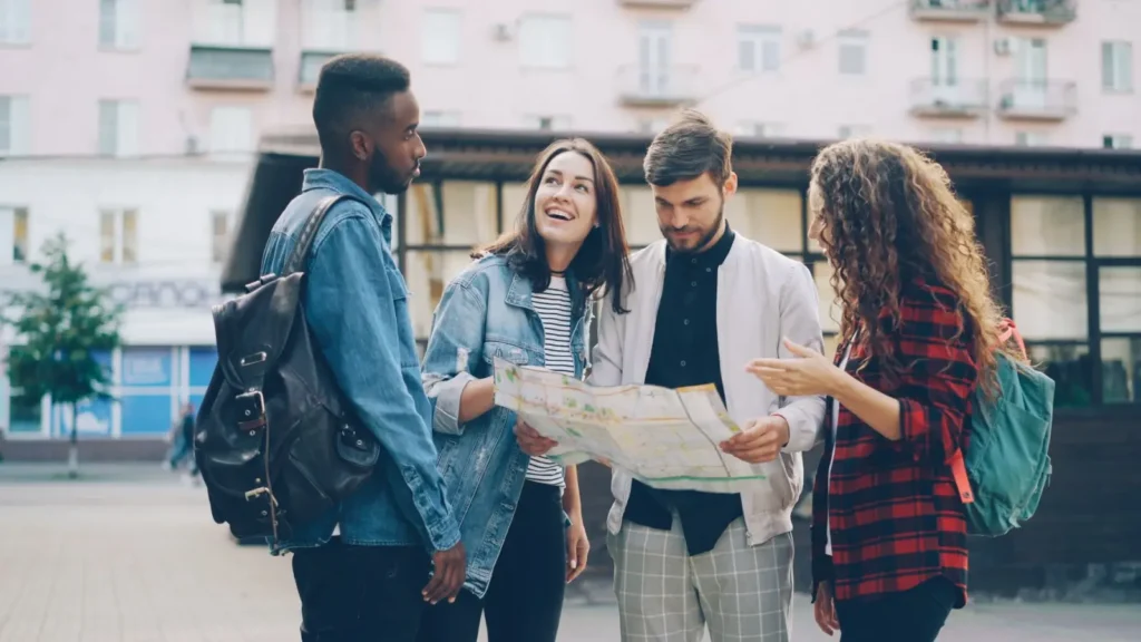 How Group Tours Work: Sizes, Costs, and What to Actually Expect ToursZoom A group tour operator discussing the day's itinerary with participants