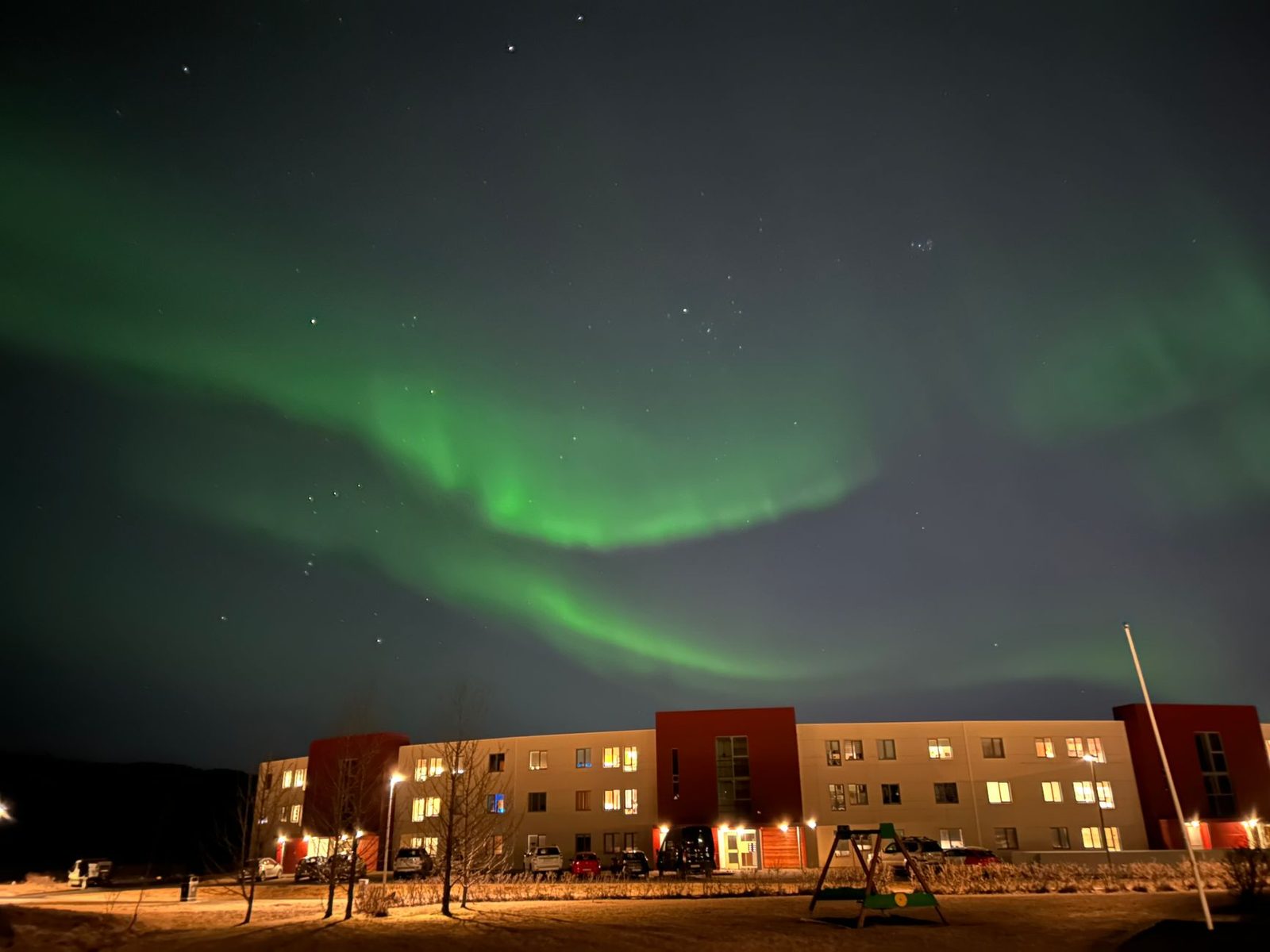 Northern Lights dancing above Reykjavik on a cold winter night