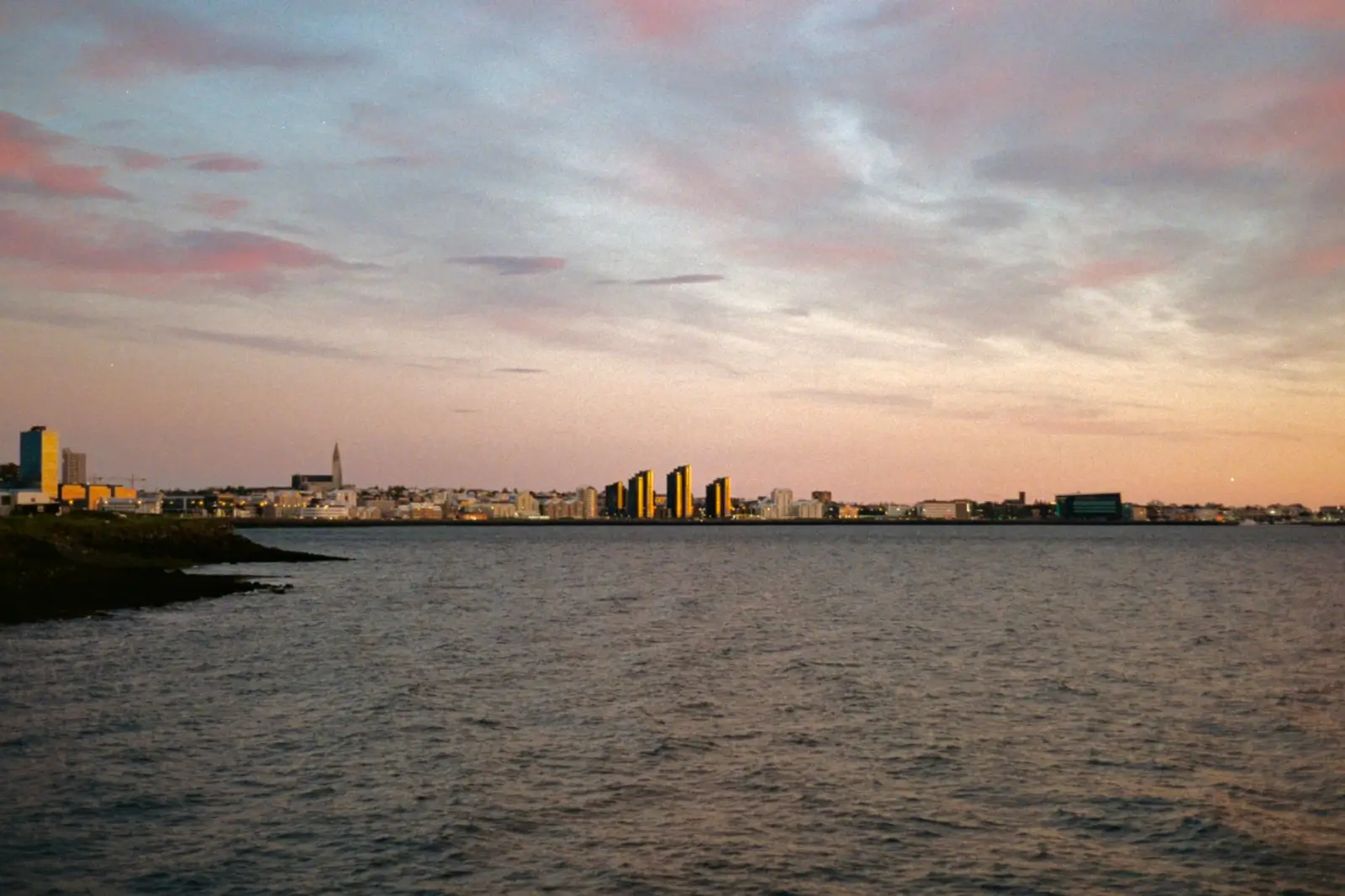 Iceland tours in September: Autumn shoulder season and first northern lights chances ToursZoom Evening view of Reykjavik skyline, showcasing the city's urban charm and lights