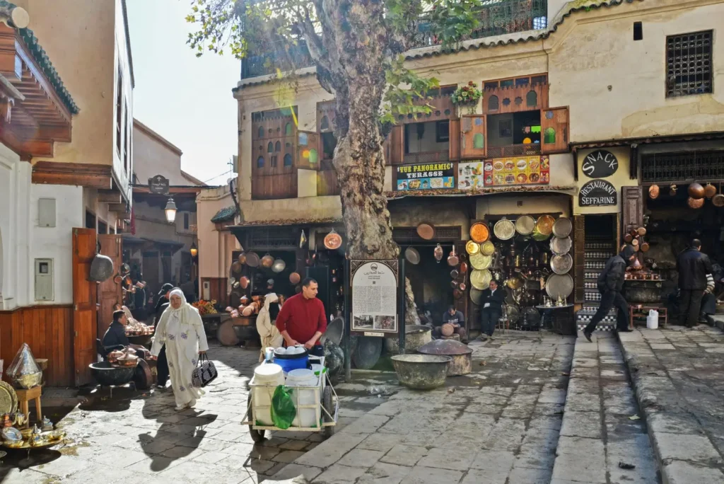 Morocco tours in October: Prime autumn desert and city touring ToursZoom Early morning scene of Fes medina with vendors and locals