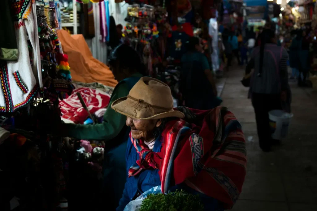 Traditional Cusco market scene bustling with activity under bright May sun