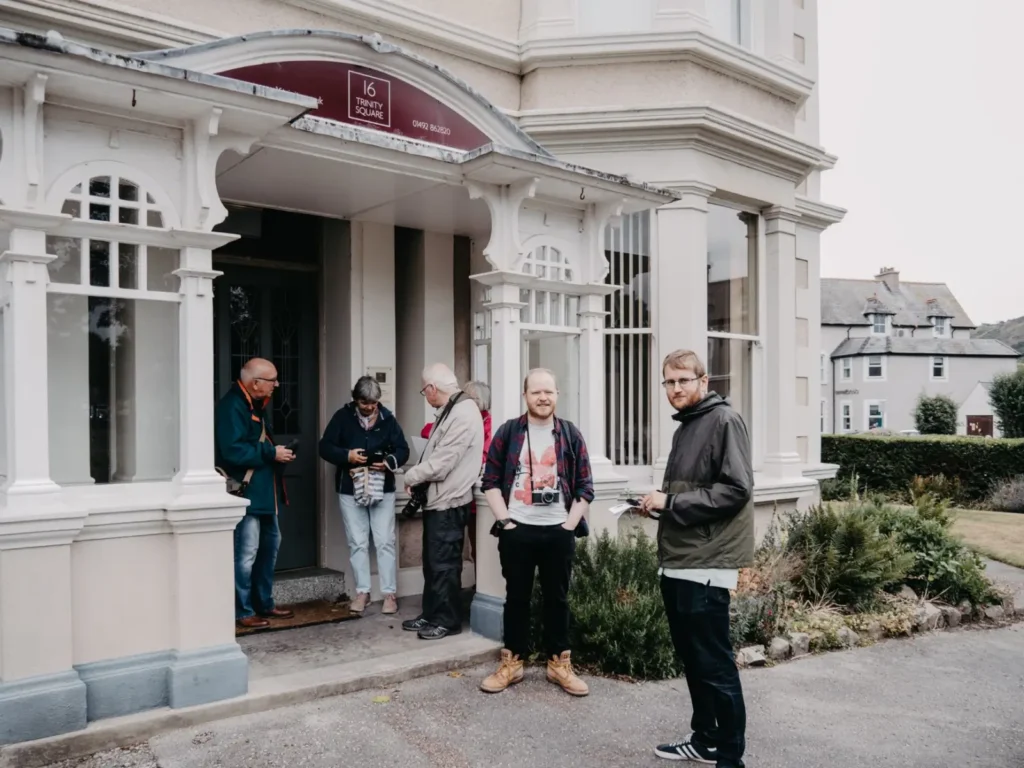 Small Group vs Private vs Large Group Tours: Which Is Right for You? ToursZoom A small group tour enjoying a meal together in a village setting, highlighting the social aspect of small group tours.