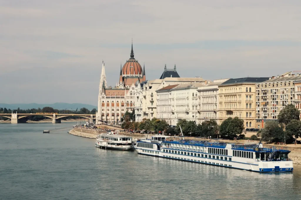 Why River Cruises Are One of the Fastest-Growing Travel Trends ToursZoom A Danube river cruise ship passing through scenic medieval towns in Hungary and Austria